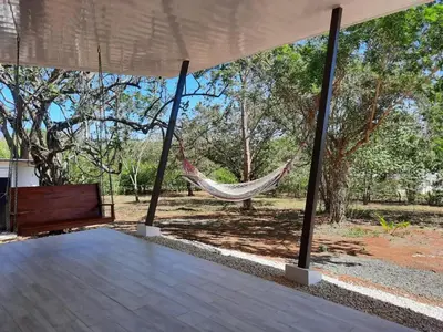 a hammock in a pavilion with a garden at Tierra de Gosén in Santa Cruz