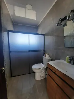 a bathroom with a toilet and a sink at Tierra de Gosén in Santa Cruz