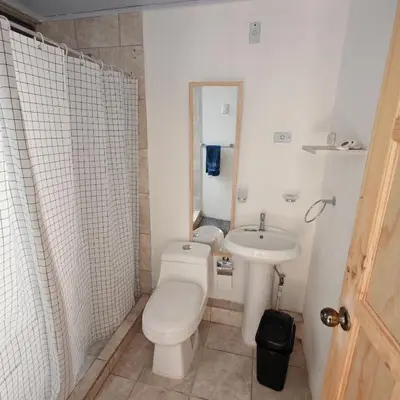 a small bathroom with a toilet and a sink at Apartamentos Las Orquideas in San Pedro