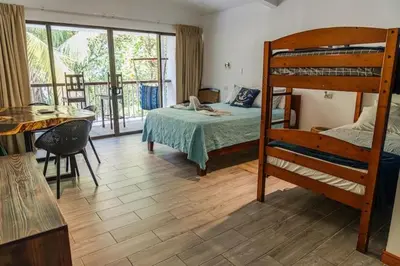 a bedroom with a bunk bed and a table at Beachfront Studio, Private Balcony with Ocean View in Tamarindo