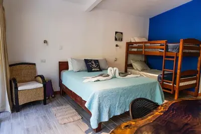 a bedroom with a bed and two bunk beds at Beachfront Studio, Private Balcony with Ocean View in Tamarindo