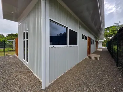 a building with a window on the side of it at Ocean Breeze at Life's a Beach in Uvita