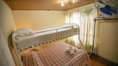 a bunk bed in a small room with a window at Villas Volcan Arenal in Fortuna