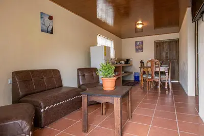 a living room with a couch and a table at Villas Volcan Arenal in Fortuna