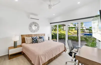 a bedroom with a bed and a sliding glass door at 3BR Villa with Pool - 10 Min Walk to Beach & Surf in Playa Avellana