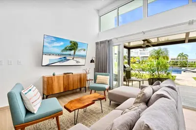 a living room with a couch and a table at 3BR Villa with Pool - 10 Min Walk to Beach & Surf in Playa Avellana