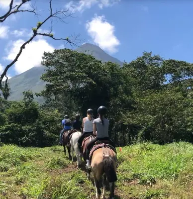 a group of people riding horses in a field at 3BR Villa with Pool - 10 Min Walk to Beach & Surf in Playa Avellana