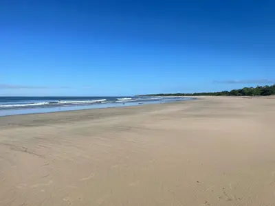 an empty beach with the ocean in the background at 3BR Villa with Pool - 10 Min Walk to Beach & Surf in Playa Avellana