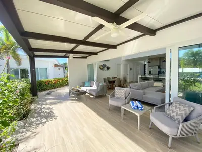 a patio with couches and a ceiling fan at 3BR Villa with Pool - 10 Min Walk to Beach & Surf in Playa Avellana