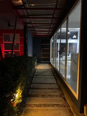 a walkway leading into a building at night at Family home in Cieneguita
