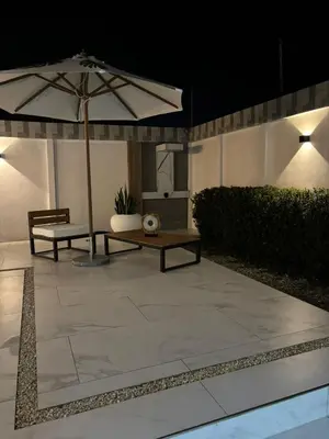 a patio with a table and an umbrella at Family home in Cieneguita
