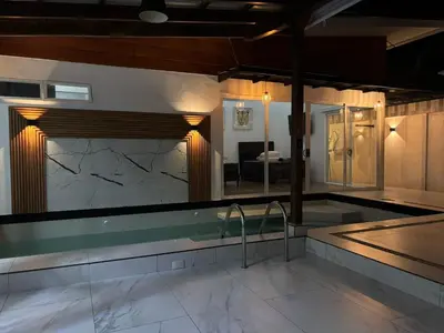 a bathroom with a swimming pool with a counter top at Family home in Puerto Limón