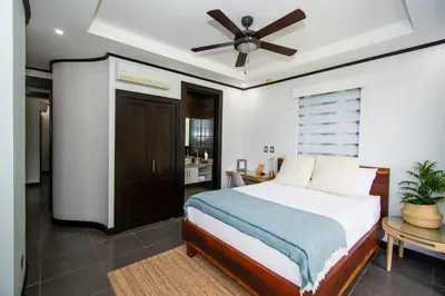 a bedroom with a bed and a ceiling fan at Ocean-Mountain views 2 Bdr, Villa Pelicano in Dominicalito