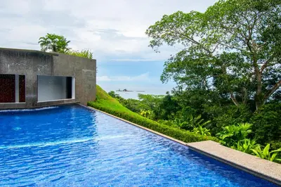 a swimming pool with a view of the ocean at Ocean-Mountain views 2 Bdr, Villa Pelicano in Dominicalito