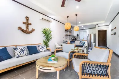 a living room with a couch and chairs and a table at Ocean-Mountain views 2 Bdr, Villa Pelicano in Dominicalito