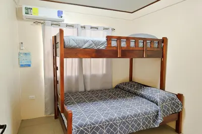 a bunk bed in a room with a blue bed sidx sidx at Casa Aldama with private pool Near Playa Tamarindo in Santa Cruz