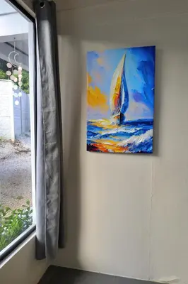 a painting of a sailboat on a wall next to a window at Casa Aldama with private pool Near Playa Tamarindo in Santa Cruz