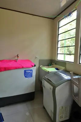 a small room with a bed and a window at Casa Aldama with private pool Near Playa Tamarindo in Santa Cruz