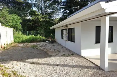 a white house with a gravel driveway at Casa Aldama with private pool Near Playa Tamarindo in Santa Cruz