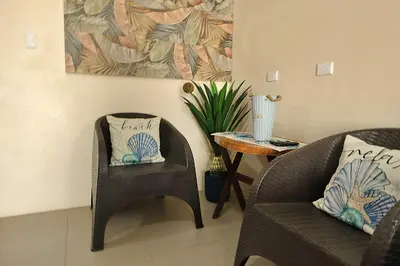 a living room with two chairs and a table at Casa Aldama with private pool Near Playa Tamarindo in Santa Cruz