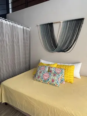 a bed with two pillows on it in a room at Chukita Loft en Villa Ron Dafa in Fraijanes