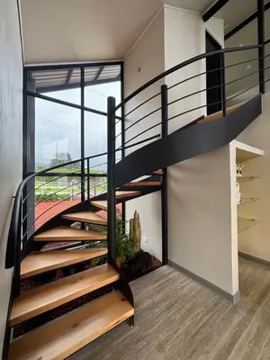 a spiral staircase in a house with a view at Chukita Loft en Villa Ron Dafa in Fraijanes