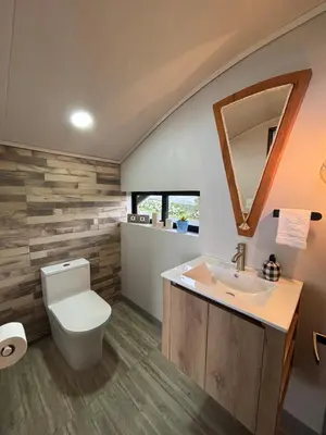 a bathroom with a toilet and a sink at Chukita Loft en Villa Ron Dafa in Fraijanes