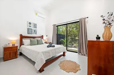 a bedroom with a bed and a large window at Casa 6 Palmas Jungle Hideaway with Private Pool in Tamarindo