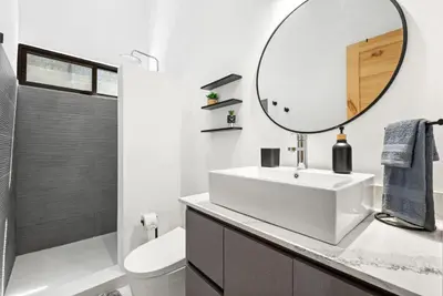 a white bathroom with a sink and a mirror at Casa 6 Palmas Jungle Hideaway with Private Pool in Tamarindo