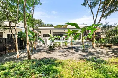 an exterior view of a house with trees at Casa 6 Palmas Jungle Hideaway with Private Pool in Tamarindo