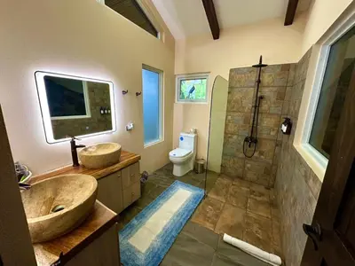 a bathroom with a large sink and a shower at Alma del Poas in Poasito