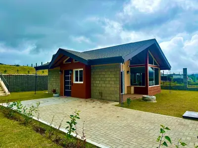 a small house with a brick patio at Alma del Poas in Poasito