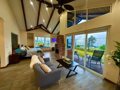 a large living room with a couch and a bed at Alma del Poas in Poasito