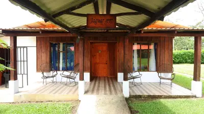 a porch with chairs and a sign that reads front yard at Enchanted Valley CR in San Lorenzo