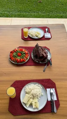 a table with two plates of food with meat and vegetables at Enchanted Valley CR in San Lorenzo