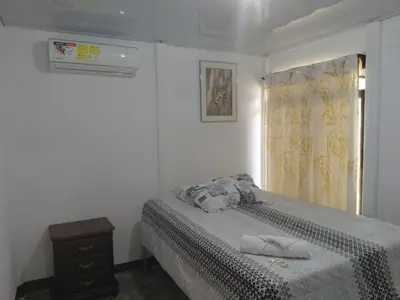 a white bedroom with a bed and a window at Inmoexito Eco Tours in Upala