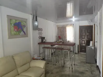 a living room with a couch and a table at Inmoexito Eco Tours in Upala