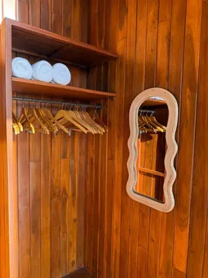 a room with a mirror and a wooden wall at Casa Canopy in Manzanillo