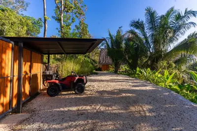 a small red atv parked under a shed at Casa Canopy in Manzanillo