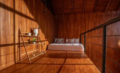 a bedroom with a bed in a wooden wall at Casa Canopy in Manzanillo