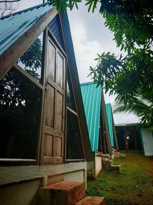 a house with a window and a blue roof at Casa Tucán in Ángeles