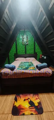a bedroom with a bed in a attic at Casa Tucán in Ángeles