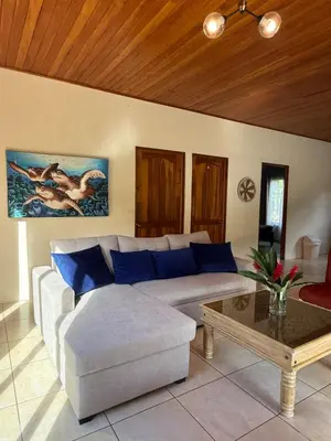 a living room with a couch and a coffee table at Casa Jardín Arenal in San Francisco