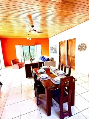 a living room with a wooden table and chairs at Casa Jardín Arenal in San Francisco