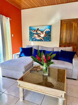 a living room with a couch and a coffee table at Casa Jardín Arenal in San Francisco