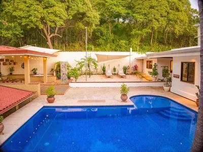 a swimming pool in the backyard of a house at Walk to Beach - Hot Tub - Pool - Comfort & Space in Coco