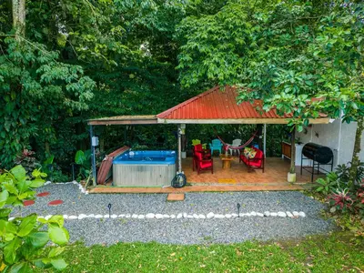 a backyard with a pool and a red roof at Toucan River Retreat - River Access, AC & Jacuzzi in San Francisco