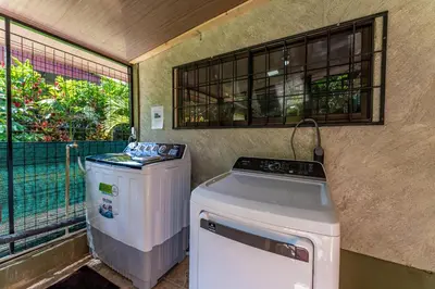a washer and dryer in a room with a window at Toucan River Retreat - River Access, AC & Jacuzzi in San Francisco