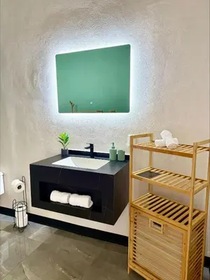 a bathroom with a sink and a mirror at Arenal Star Luxury Studios with Private Jacuzzi in Fortuna