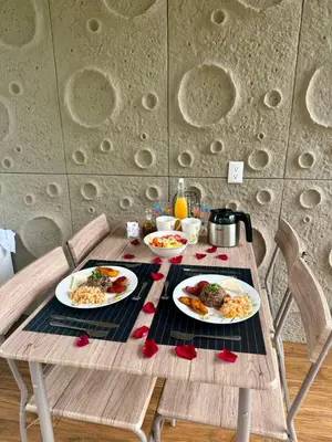 a wooden table with plates of food on it at Arenal Star Luxury Studios with Private Jacuzzi in Fortuna